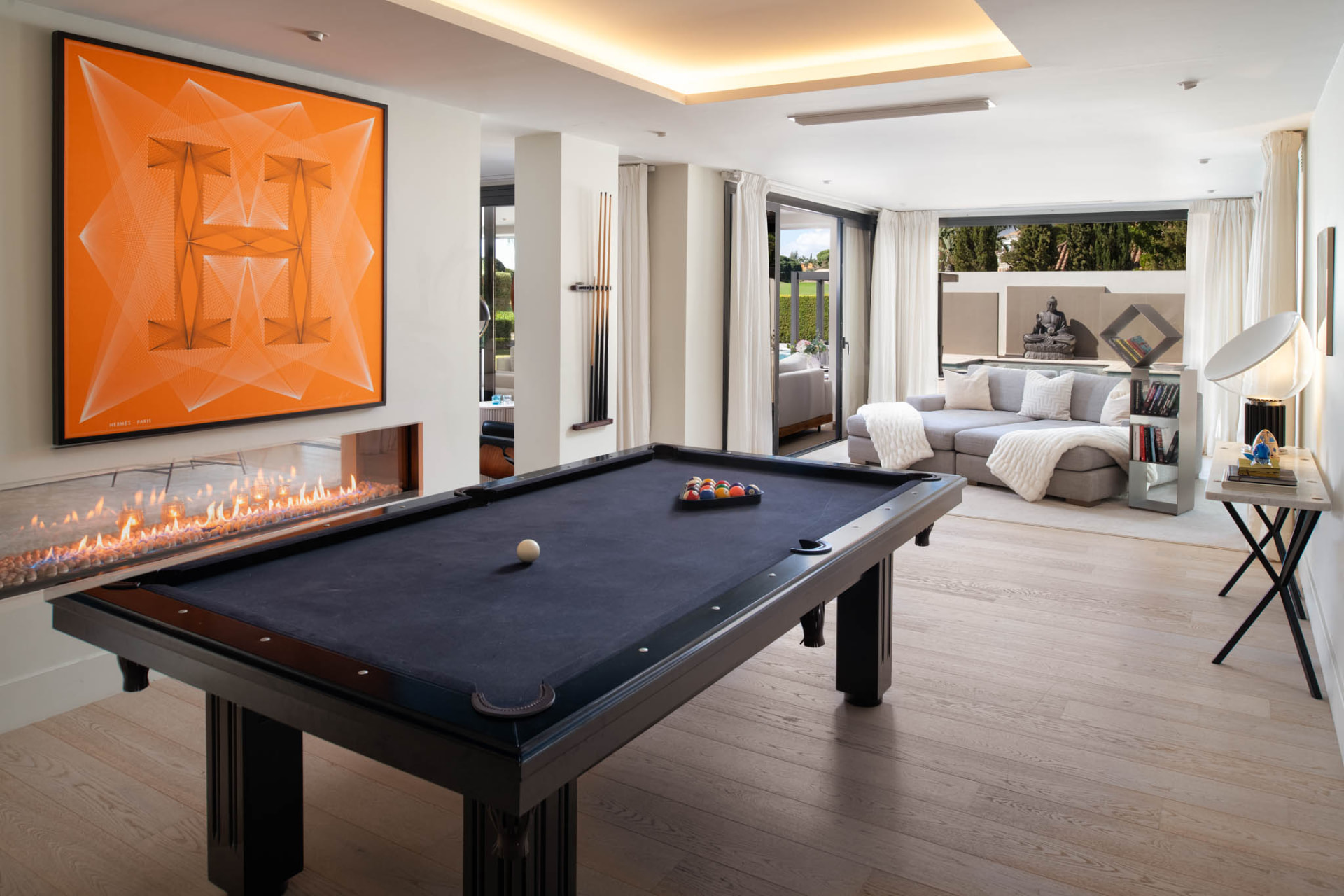 The billiards room with a linear fireplace.