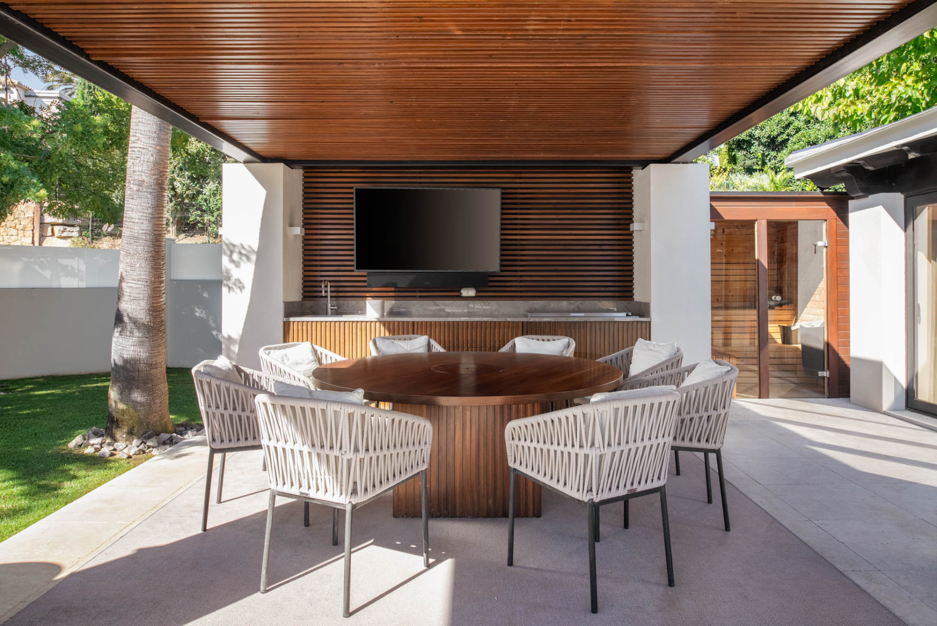 The covered outdoor dining and bar area beside the pool terrace.